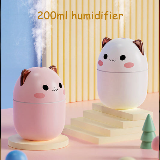 Air Humidifier in cute cat design, 200 ml pink and white USB cool-mist diffuser with LED night-light, vapor rising on pastel desk