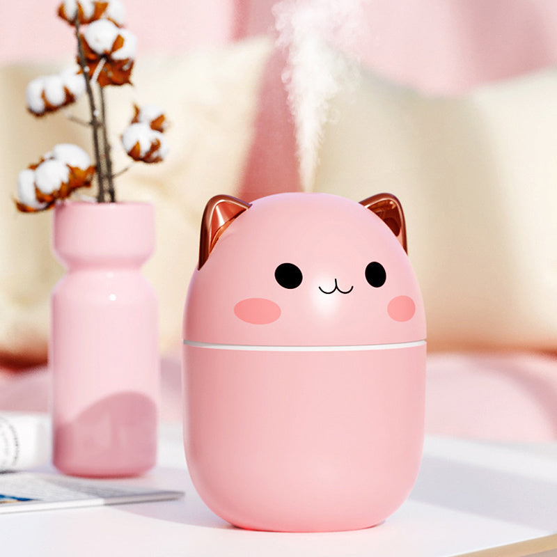 Pink USB Air Humidifier in cute cat shape spraying steady mist, colorful backdrop enhances portable design